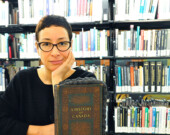 Chantal Gibson with one of her artworks – the Braided Book – a mixed media, altered history of Canada, published in 1936. | Photo courtesy of Place des Arts